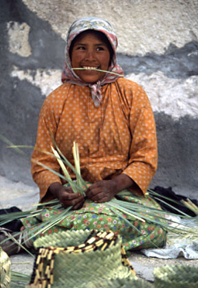 In Mexico's Copper Canyon, a Tarahumara lady weaves a basket.